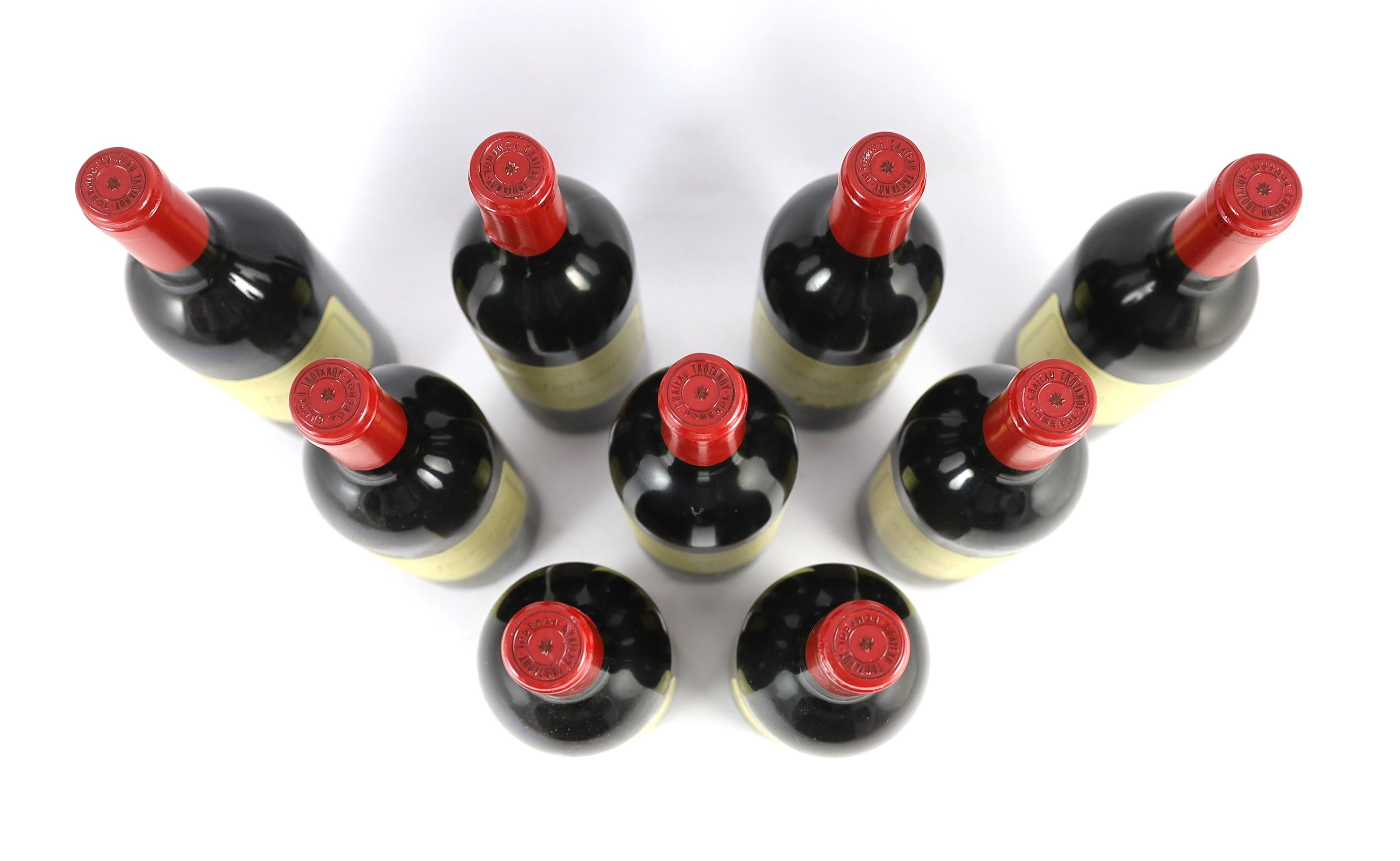 Nine bottles of Chateau Trotanoy Pomerol 1999, height 30cm